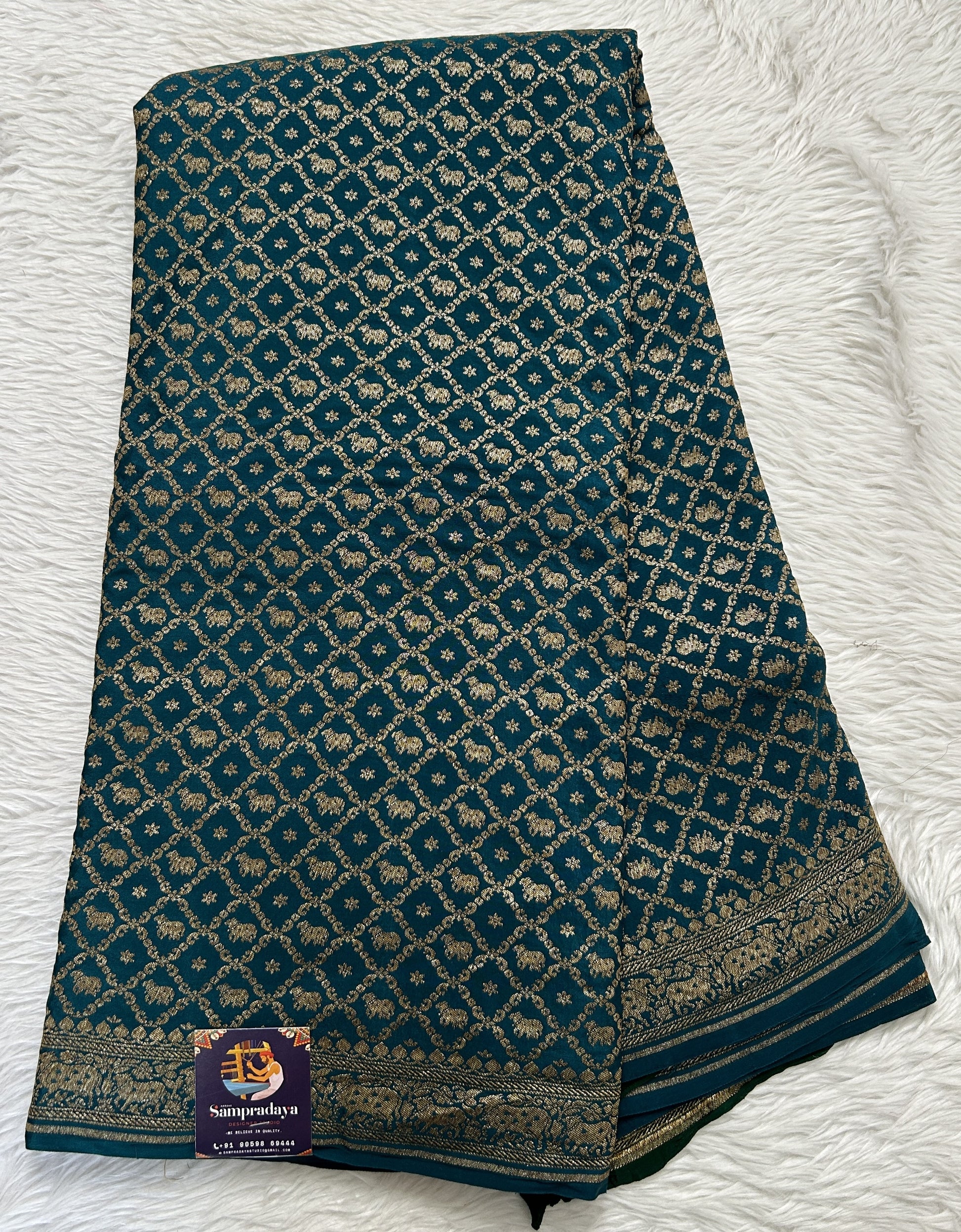 Banarasi Georgette Saree Peacock Blue Colored Complemented with a Zari Border. - Sampradaya Designer Studio