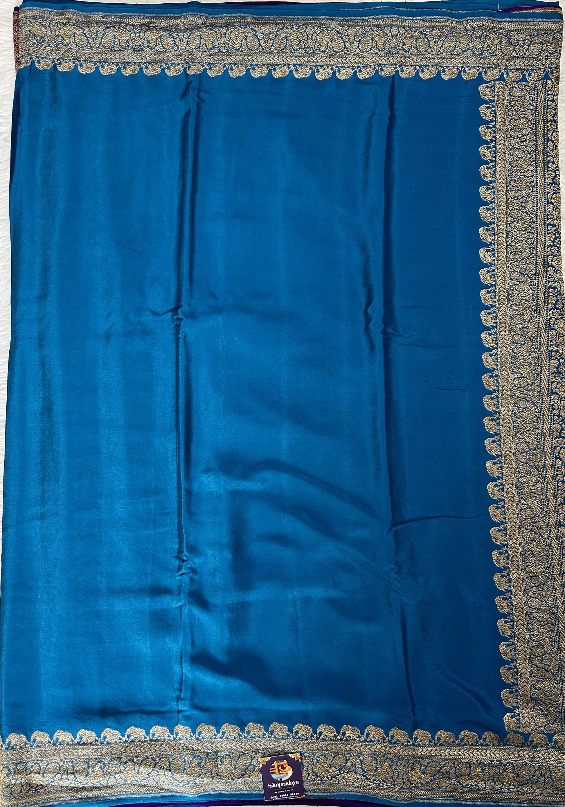 Banarasi Georgette Saree Peacock Blue Colored Complemented with a Zari Border. - Sampradaya Designer Studio