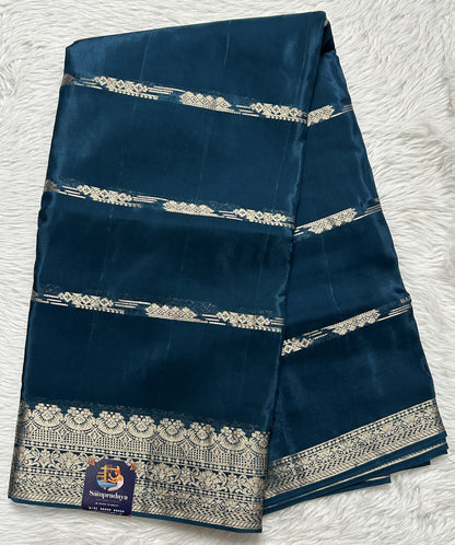 Satin Georgette Saree Peacock Blue Colored Complemented with a Zari Border. - Sampradaya Designer Studio