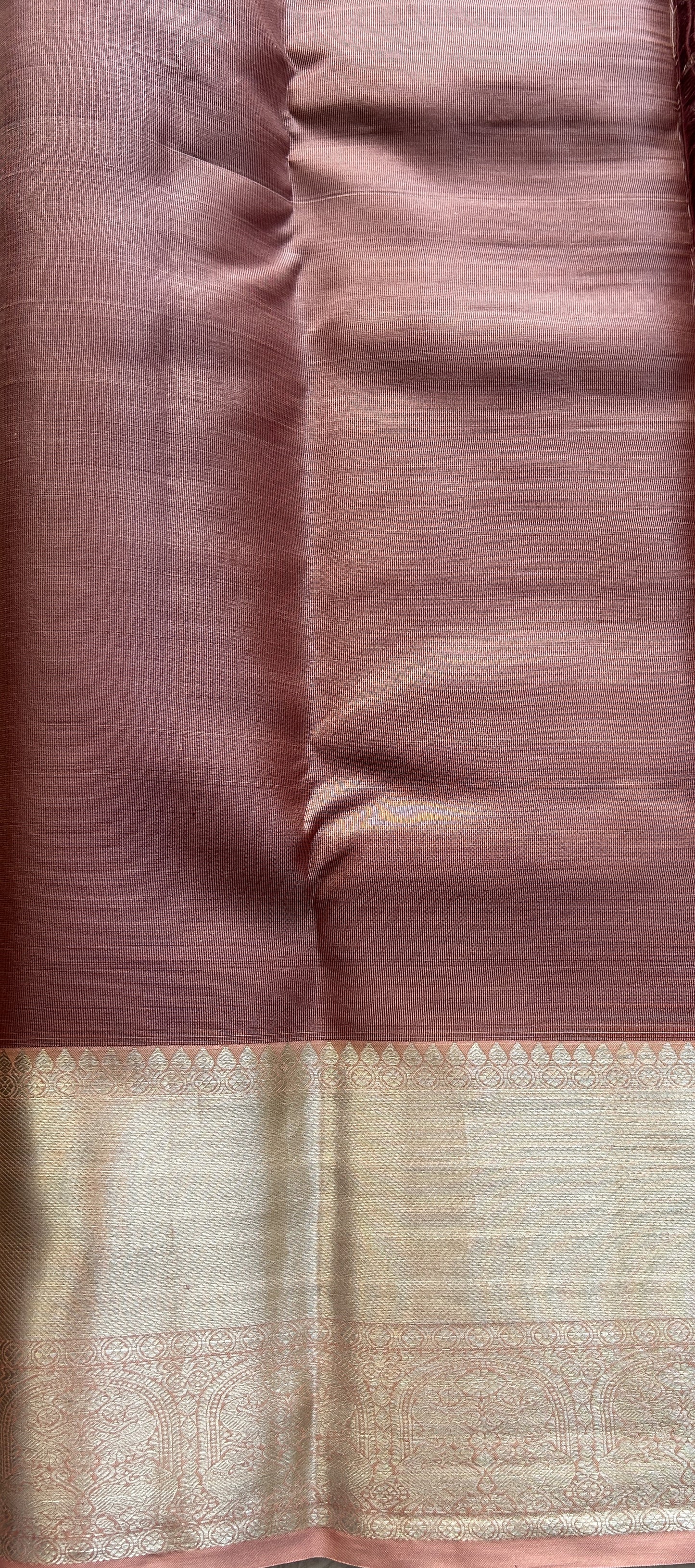 Kanjivaram Bridal Silk Saree Pale Orange colored Saree complemented with a Zari border.