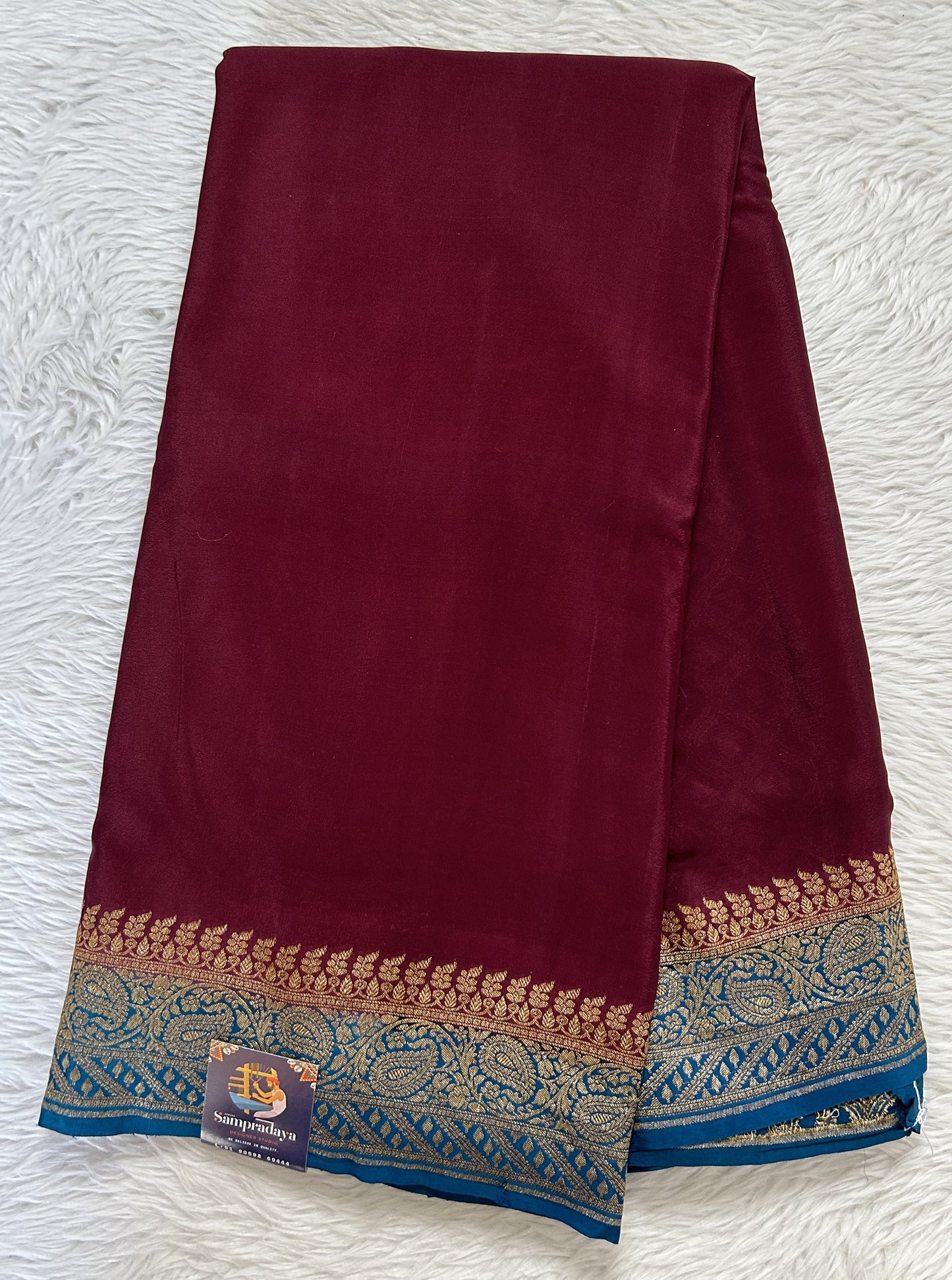 Banarasi Georgette Saree Brown Colored Complemented with a Peacock Blue Zari border. - Sampradaya Designer Studio