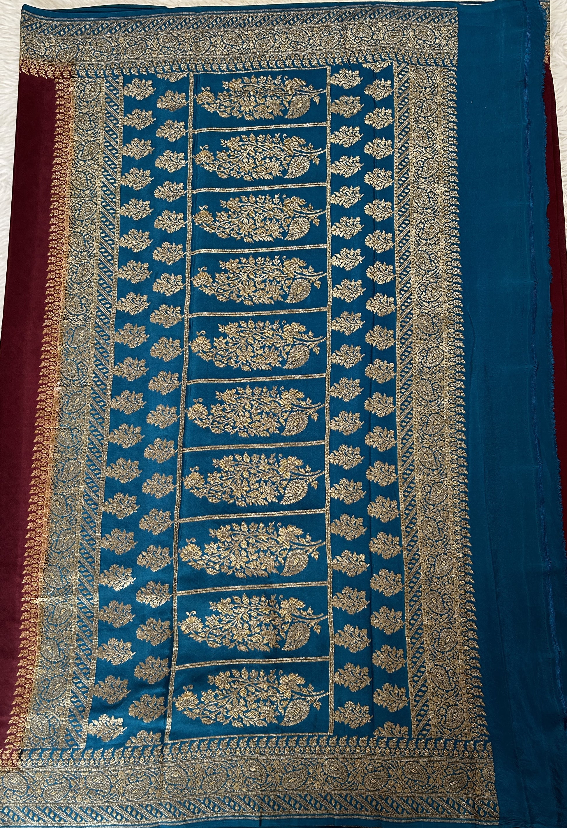 Banarasi Georgette Saree Brown Colored Complemented with a Peacock Blue Zari border. - Sampradaya Designer Studio