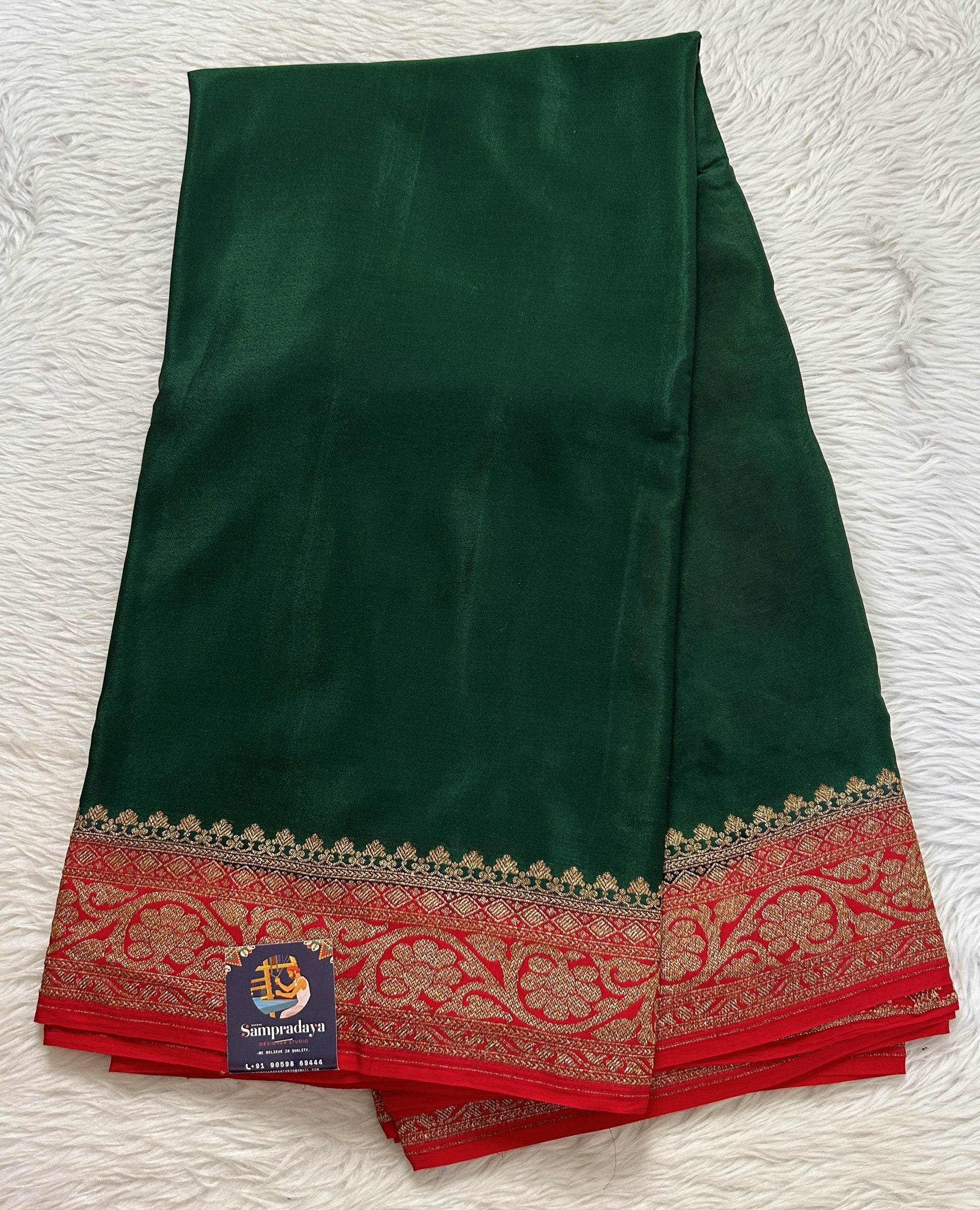 Banarasi Georgette Saree Bottle Green Colored Complemented with a Red Color Zari border. - Sampradaya Designer Studio