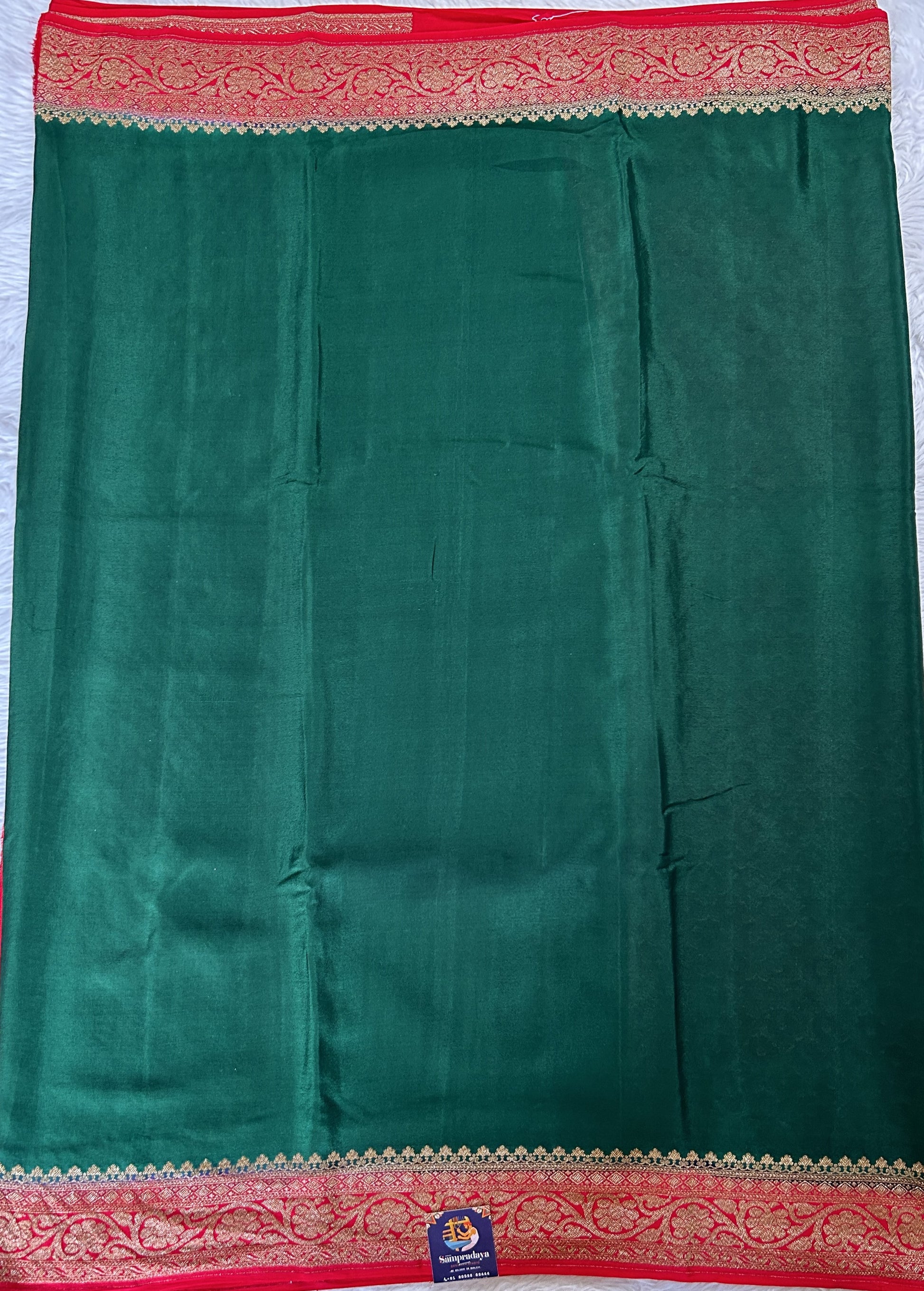 Banarasi Georgette Saree Bottle Green Colored Complemented with a Red Color Zari border. - Sampradaya Designer Studio