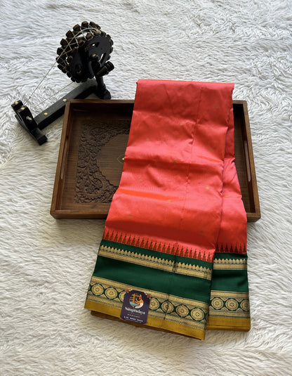 Narayanpet Silk Saree Dark Peach Colored Complemented with a Dark Green Zari Border.