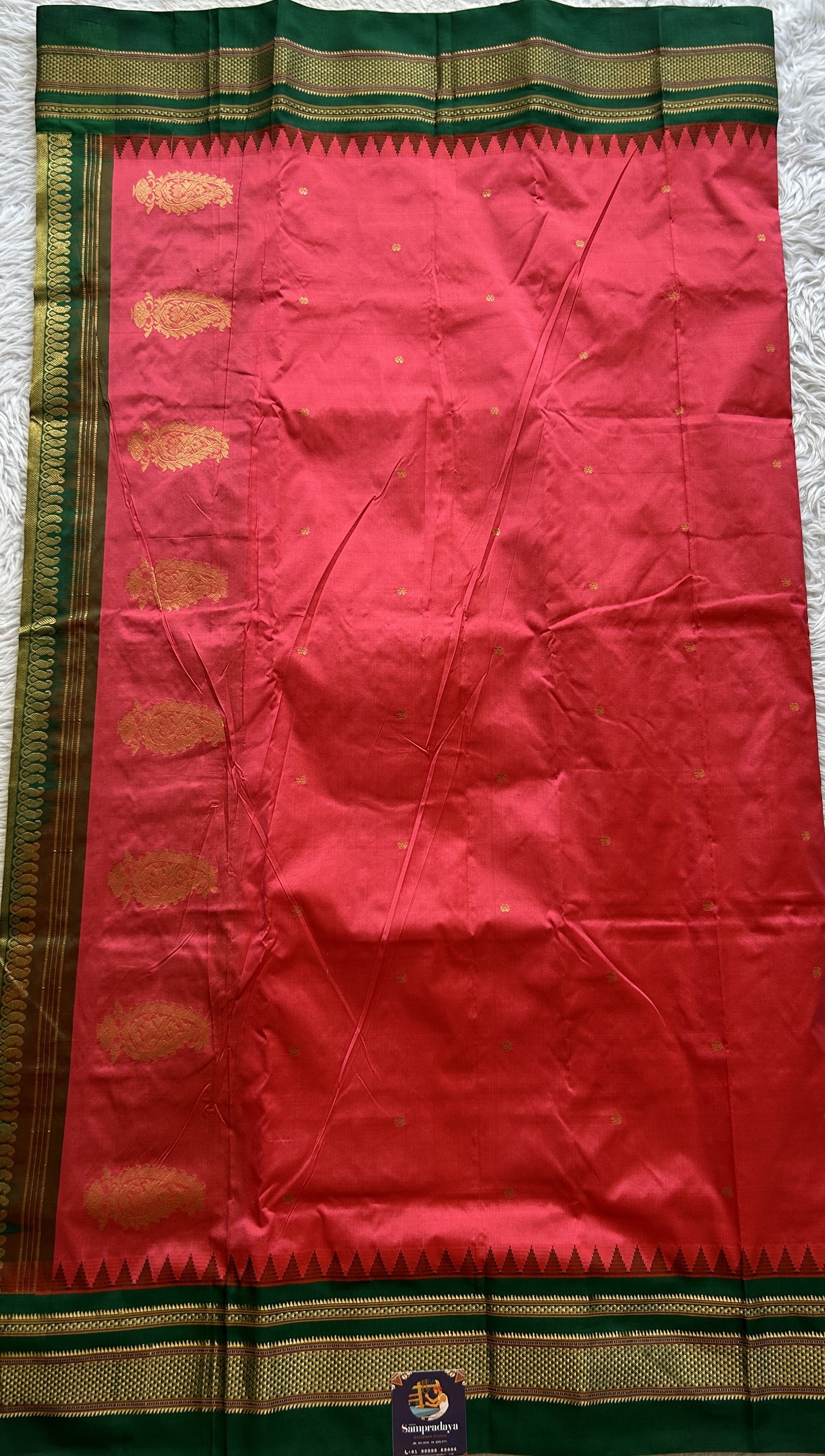 Narayanpet Silk Saree Dark Peach Colored Complemented with a Green Zari Border.