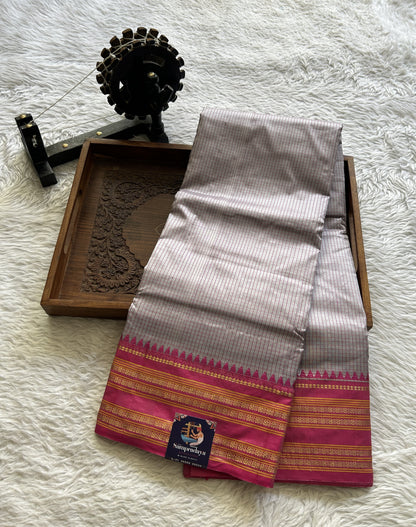 Narayanpet Silk Checks Saree Ash Colored Complemented with a Pink Zari Border.