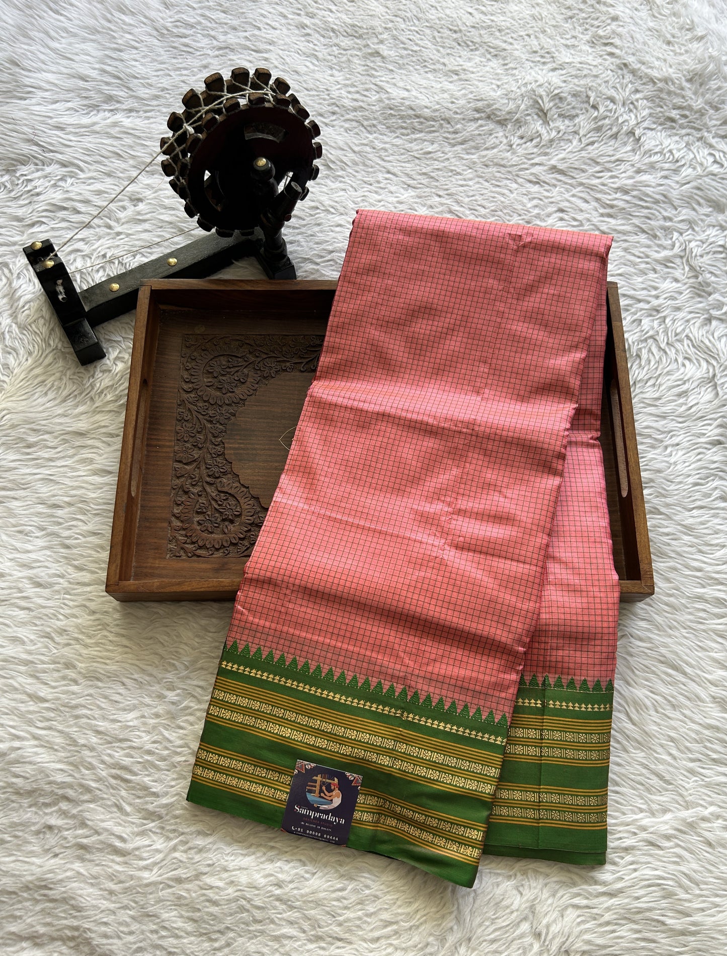 Narayanpet Silk Checks Saree Peach Colored Complemented with a Green Zari Border.