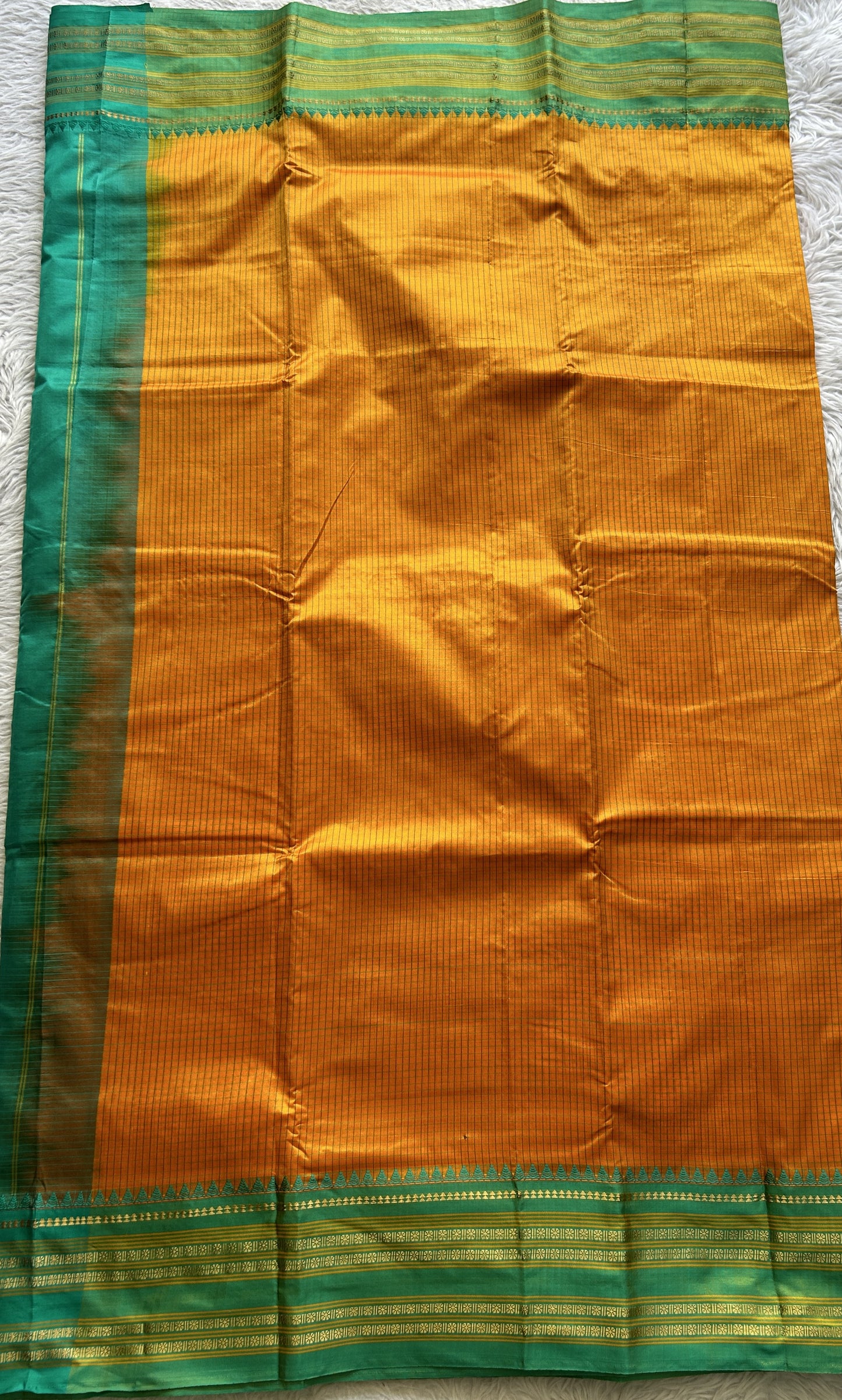 Narayanpet Silk Checks Saree Orange Colored Complemented with a Rama Green Zari Border.