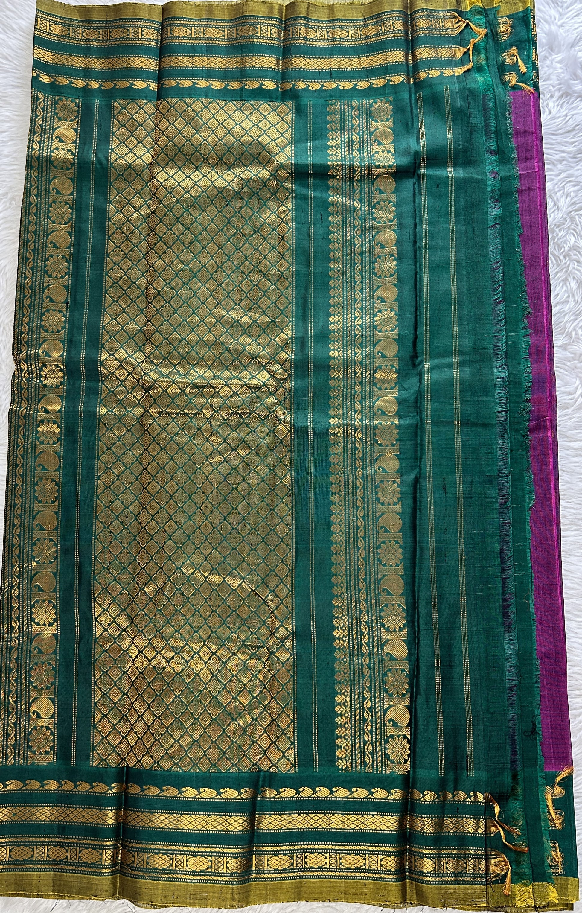 Gadwal Sico Saree Brinjal colored complemented with a Green Kanchi Gap Border. - Sampradaya Designer Studio