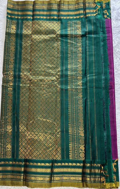 Gadwal Sico Saree Brinjal colored complemented with a Green Kanchi Gap Border. - Sampradaya Designer Studio