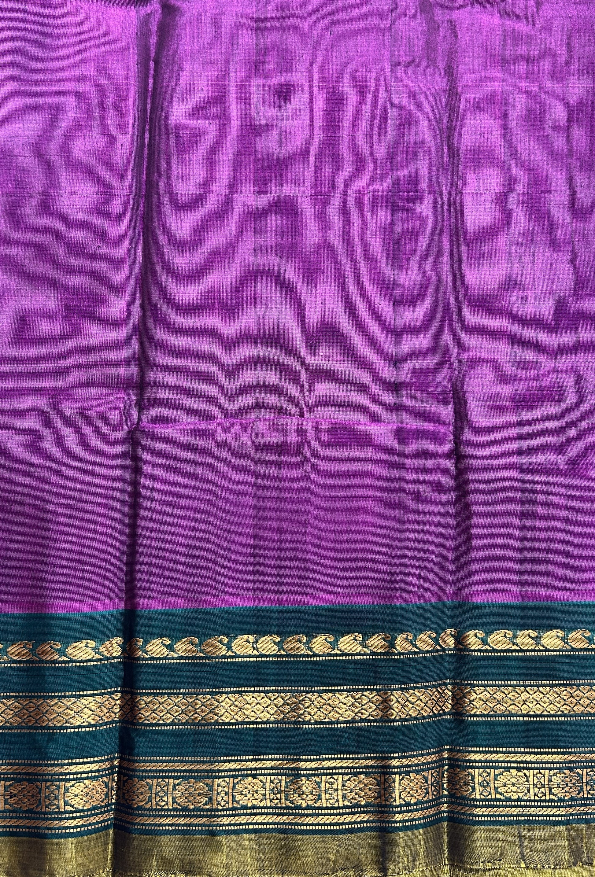 Gadwal Sico Saree Brinjal colored complemented with a Green Kanchi Gap Border. - Sampradaya Designer Studio