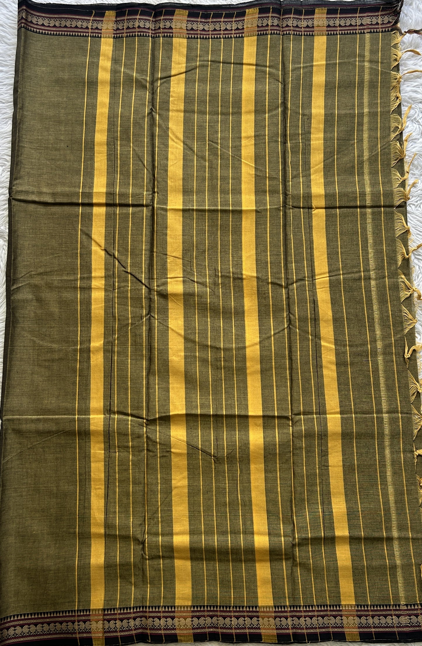 Narayanpet Cotton Saree Dark Olive Green Colored Complemented with a Thread Border.