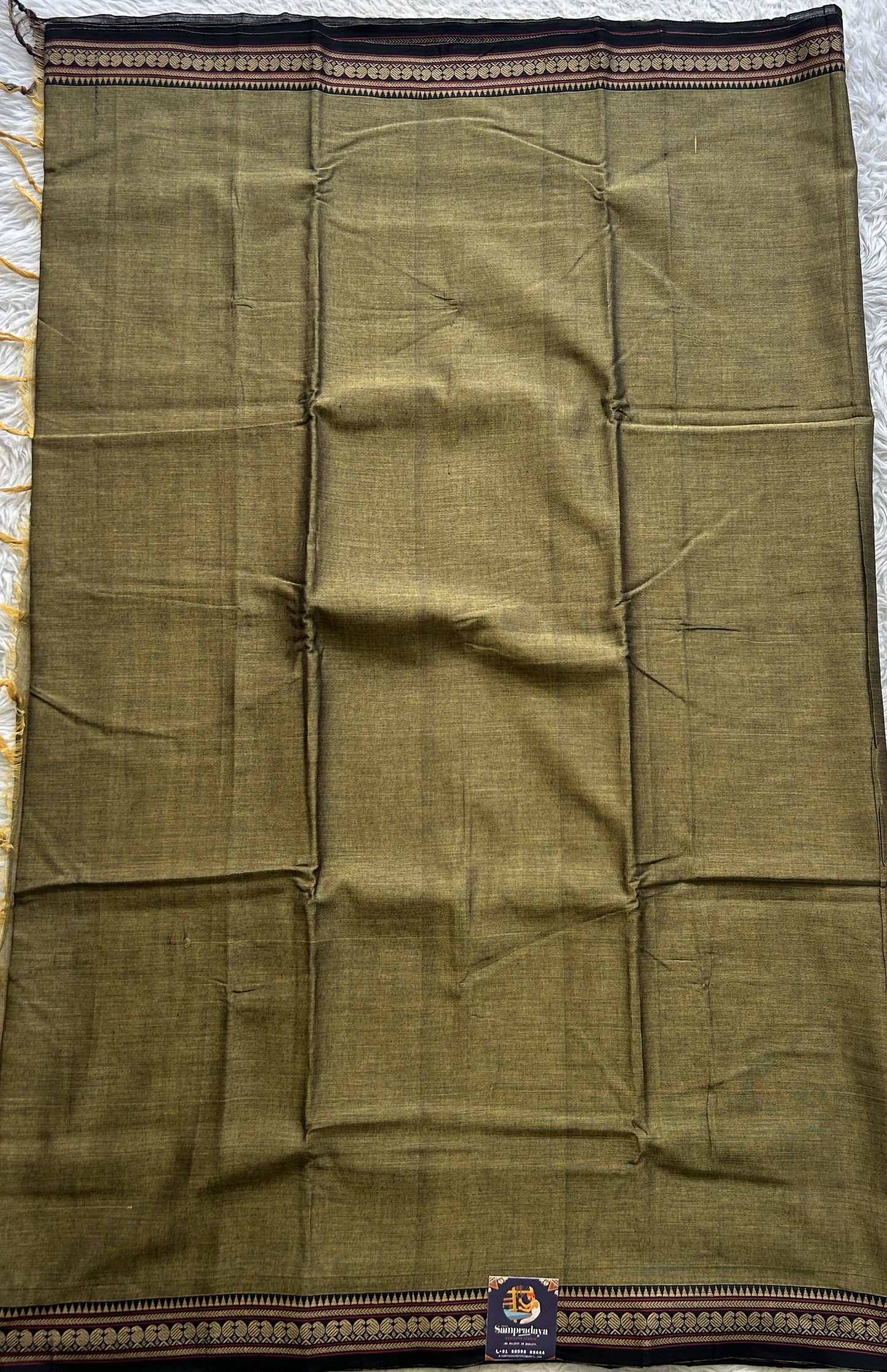 Narayanpet Cotton Saree Dark Olive Green Colored Complemented with a Thread Border.