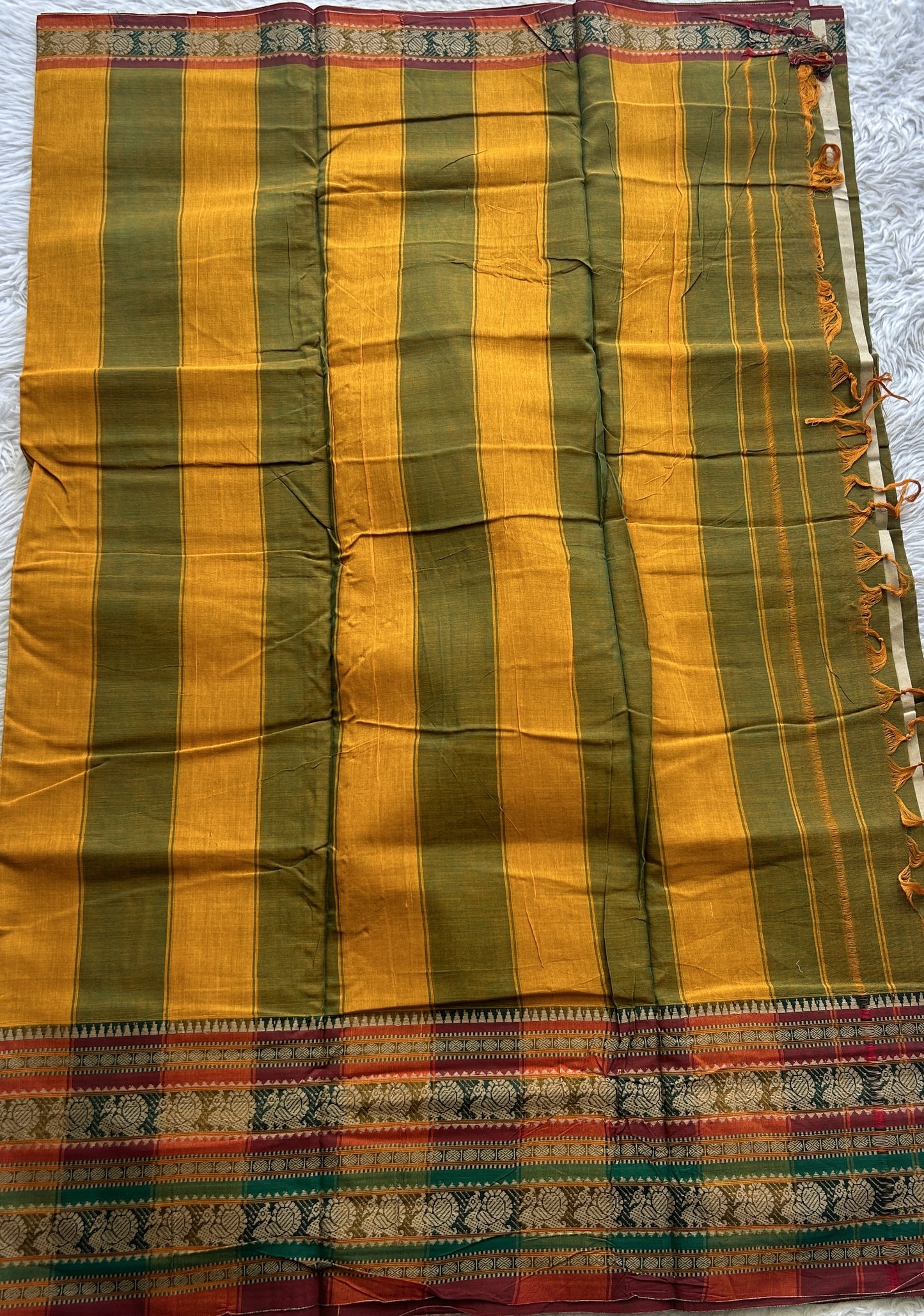 Narayanpet Cotton Saree Olive Green Colored Complemented with a Thread Border.