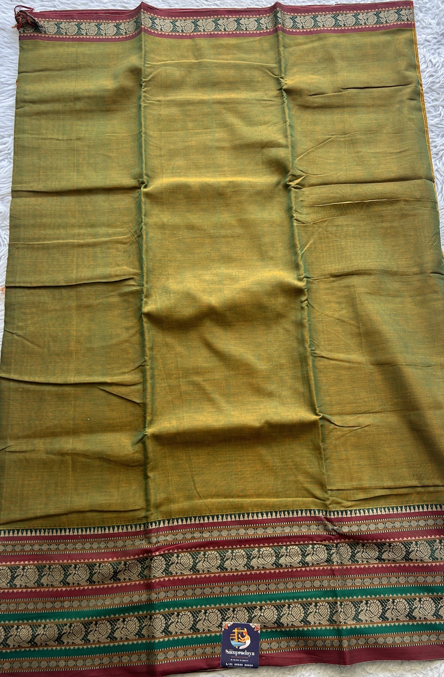 Narayanpet Cotton Saree Olive Green Colored Complemented with a Thread Border.