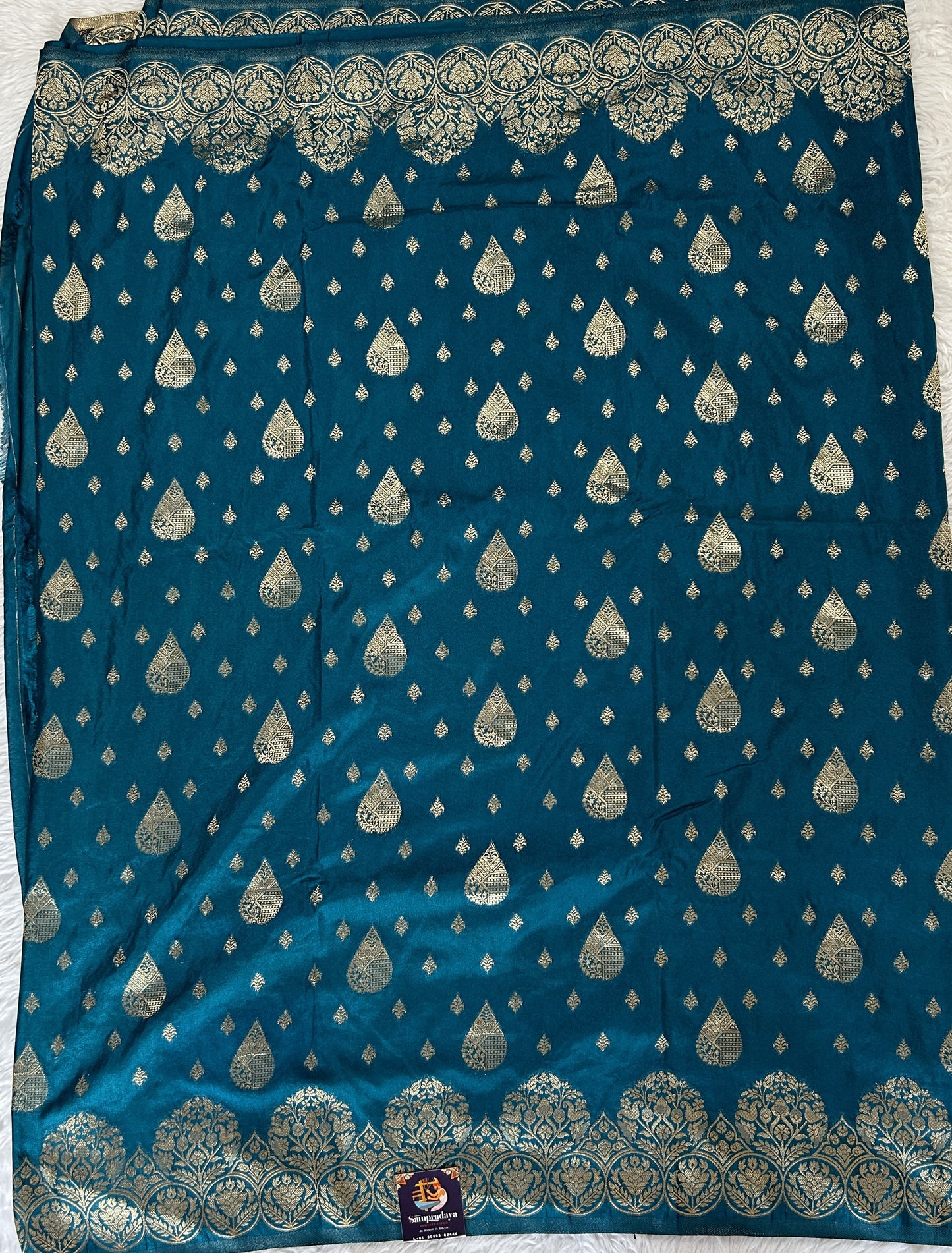 Banarasi Fancy Saree Peacock Blue Colored Complemented with a Zari Border. - Sampradaya Designer Studio