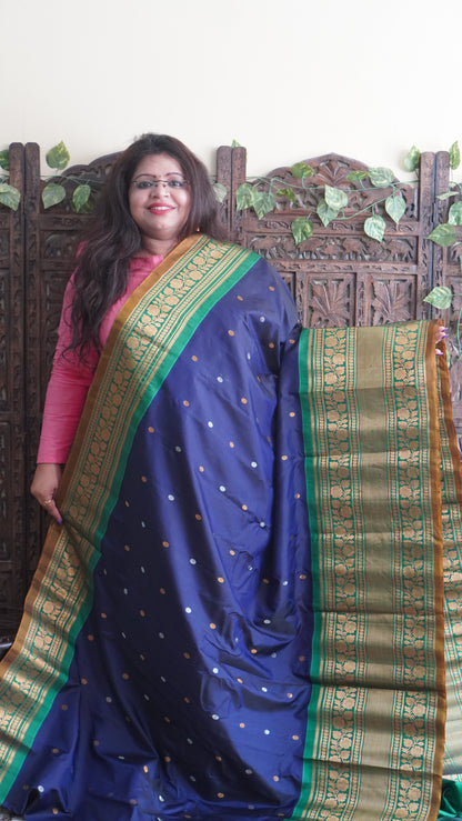 Gadwal Silk Saree Navy Blue Colored Complemented With a Green Color Zari Border