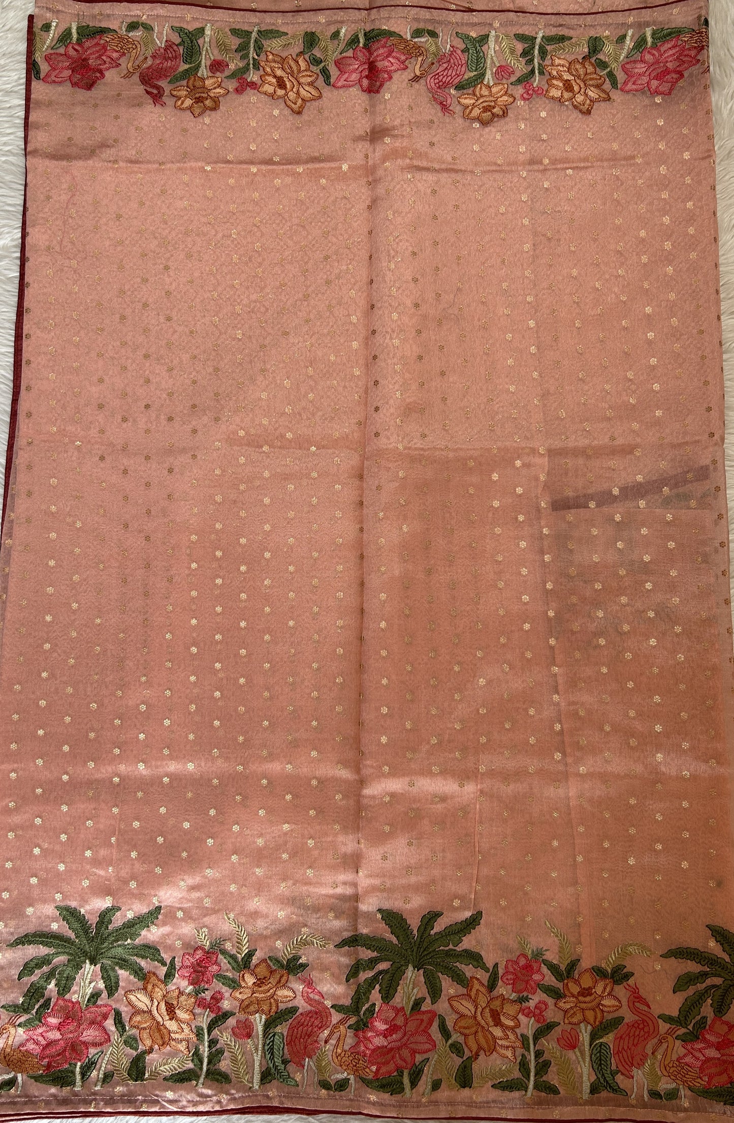 Tissue Georgette Designer Saree Coral colored complemented with a Thread Embroidery border. - Sampradaya Designer Studio