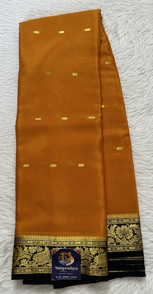 Mysore Crepe Silk Saree Orange Colored Complemented with a Black Zari Border. - Sampradaya Designer Studio