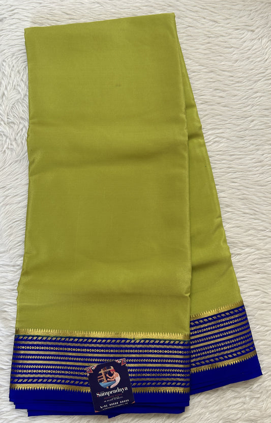 Mysore Crepe Silk Saree Light Green Colored Complemented with a Blue Zari Border. - Sampradaya Designer Studio