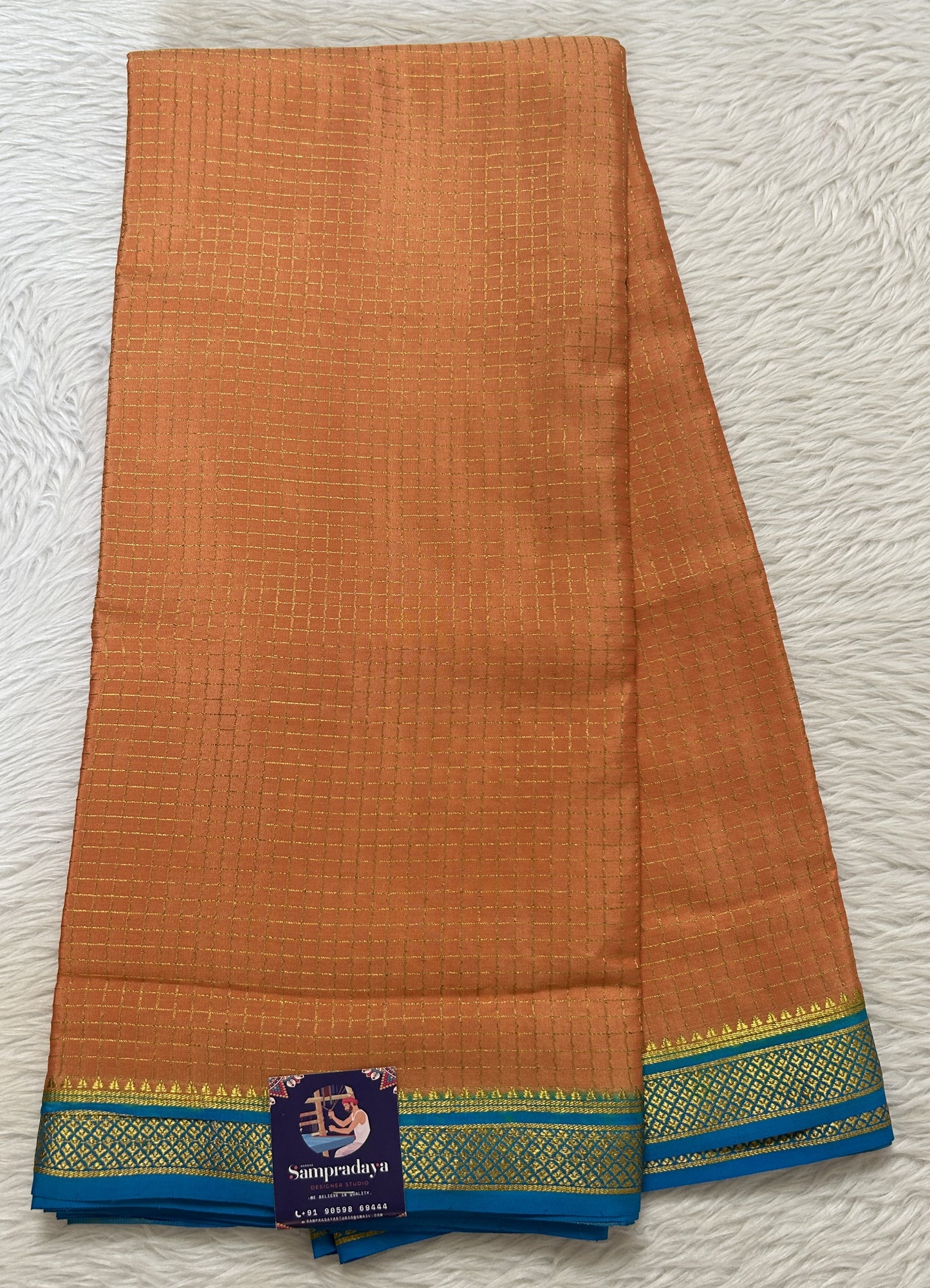 Mysore Crepe Silk Saree Light Orange Colored Complemented with a Blue Zari Border. - Sampradaya Designer Studio