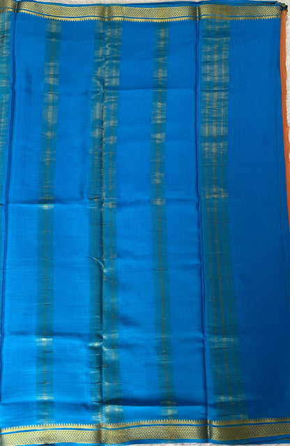 Mysore Crepe Silk Saree Light Orange Colored Complemented with a Blue Zari Border. - Sampradaya Designer Studio