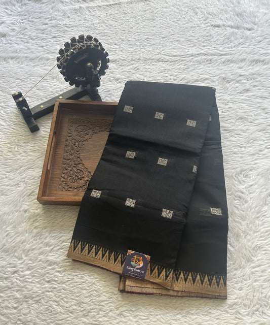 Narayanpet Cotton Buti Saree Black Colored Complemented with a Thread Border.