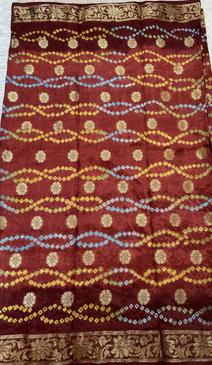 Bandhani Saree Maroon Colored Complemented with a Zari Border. - Sampradaya Designer Studio