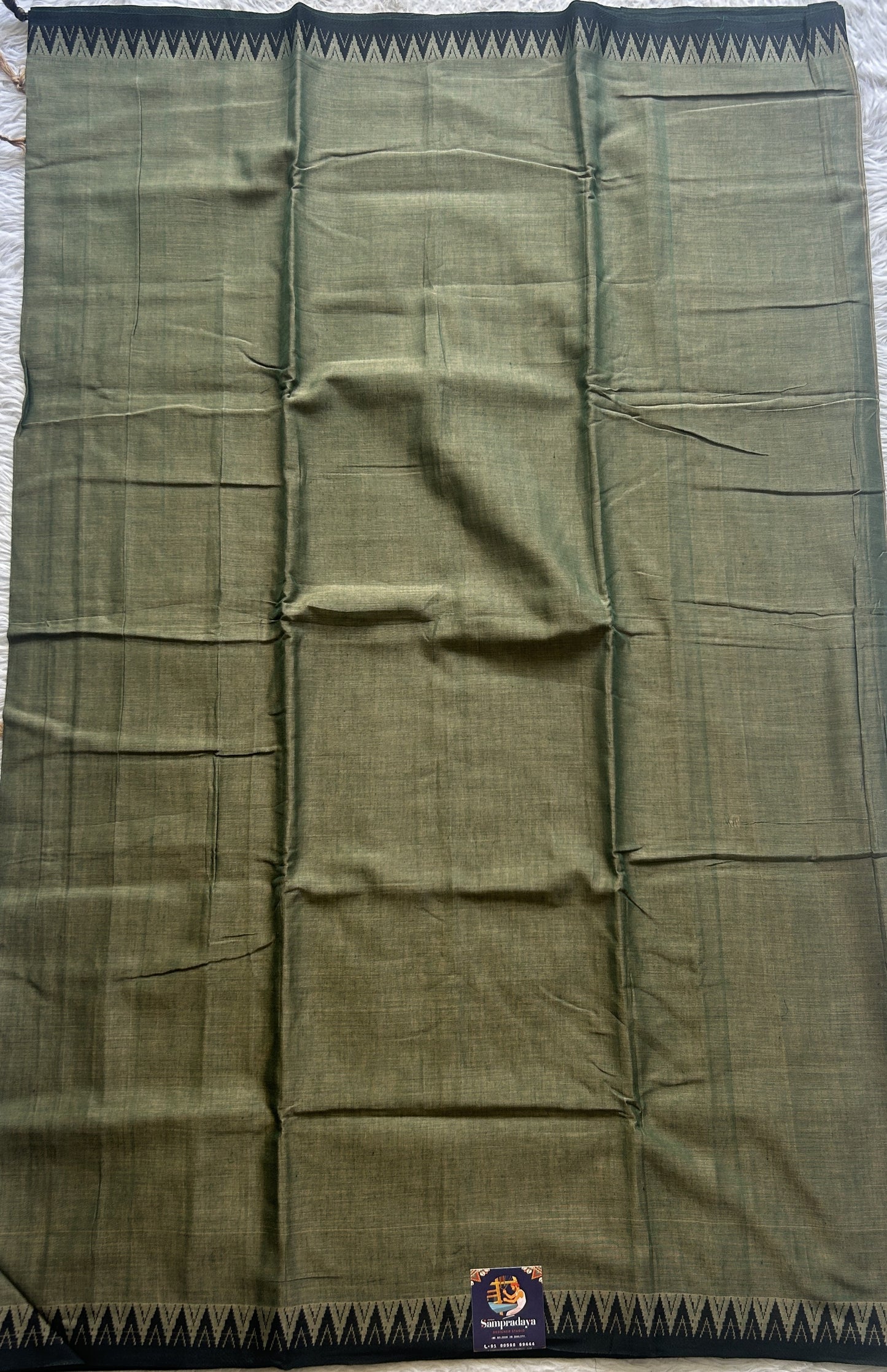 Narayanpet Cotton Saree Olive Green Colored Complemented with a Black Thread Border.