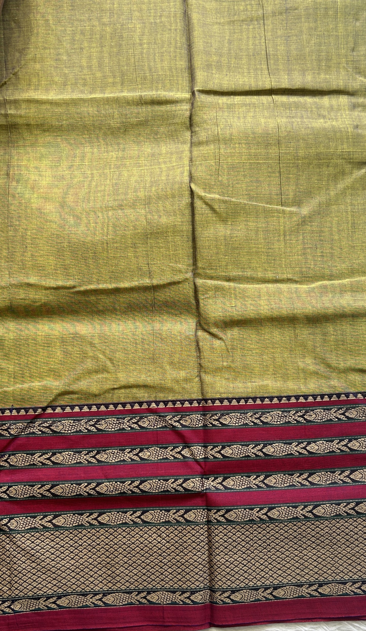 Narayanpet Cotton Saree Avocado Colored Complemented with a Thread Border.