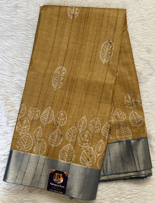 Semi Tussar Saree Wheat Color Complemented with a Blue Zari Border. - Sampradaya Designer Studio