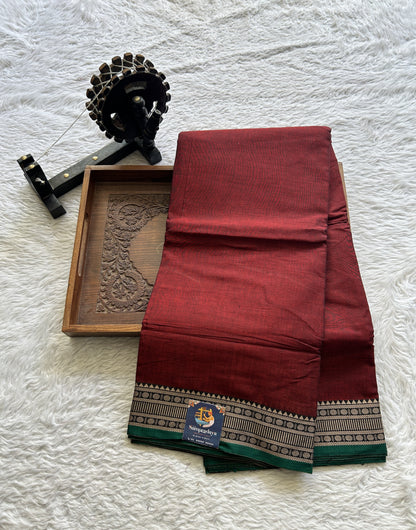 Narayanpet Cotton Saree Garnet Colored Complemented with a Thread Border.