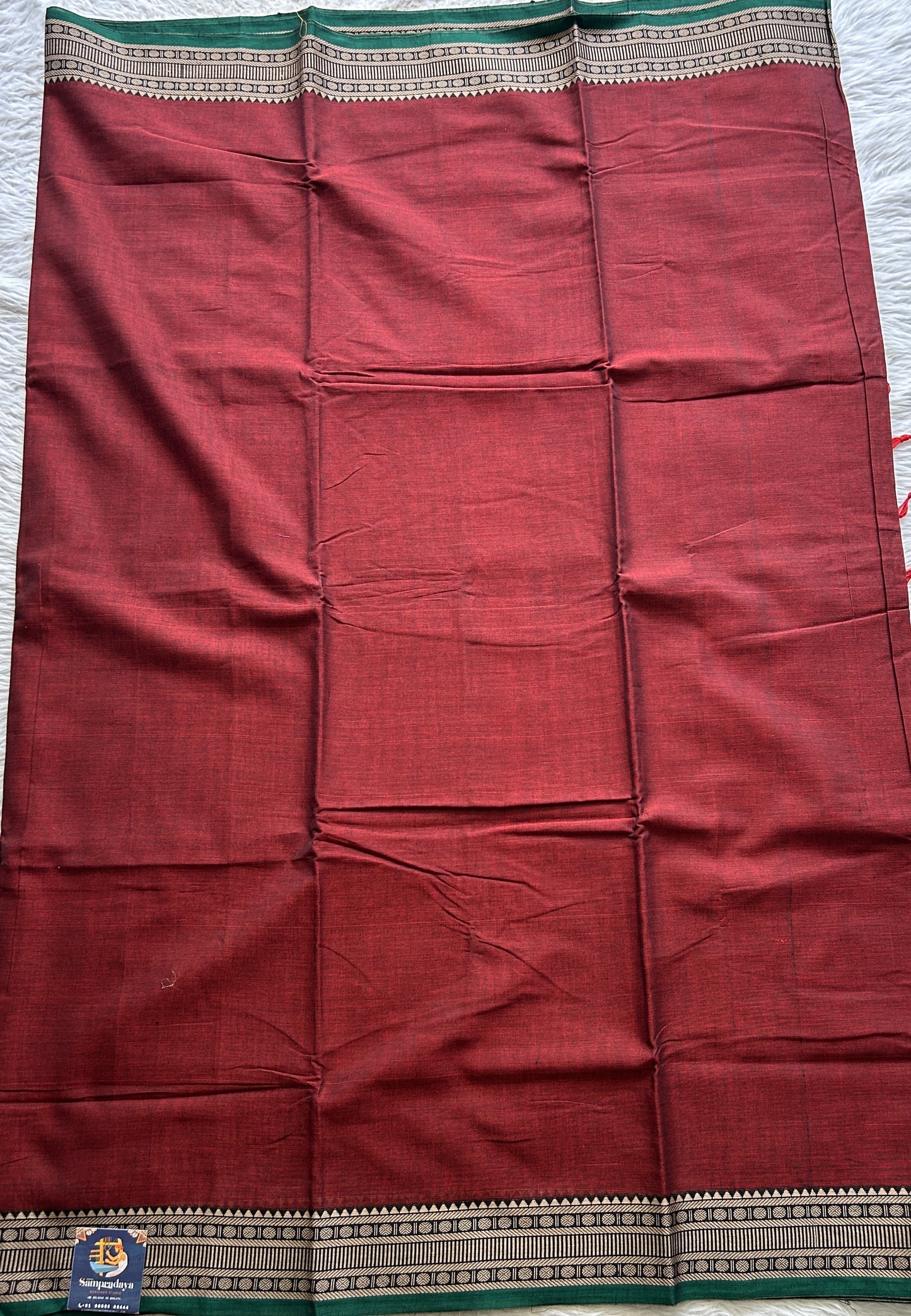 Narayanpet Cotton Saree Garnet Colored Complemented with a Thread Border.