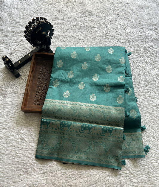 Semi Raw Silk Allover Saree Deep Dusty Blue Colored Complemented with a Zari Border.