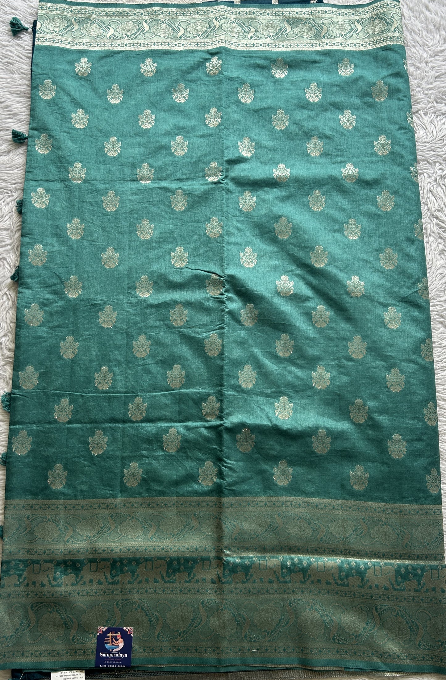 Semi Raw Silk Allover Saree Deep Dusty Blue Colored Complemented with a Zari Border.