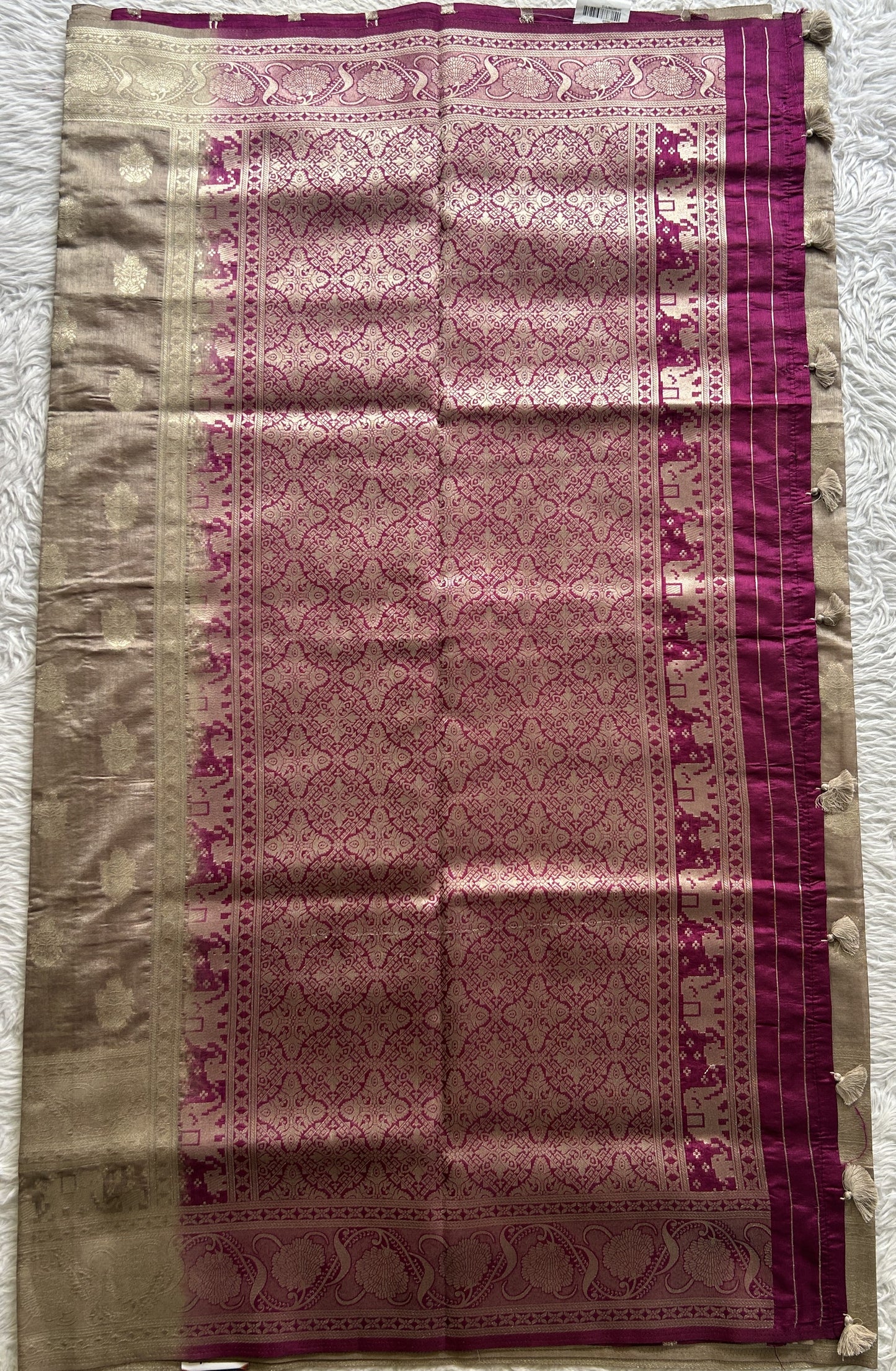 Semi Raw Silk Saree Ash Colored Complemented with a Zari Border.