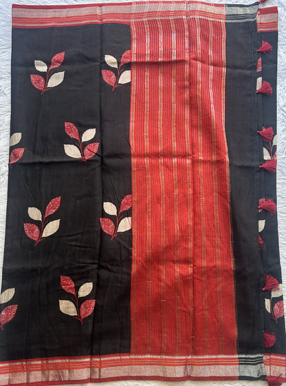 Dola Crepe Saree Black Colored Complemented with a Red Zari Border.