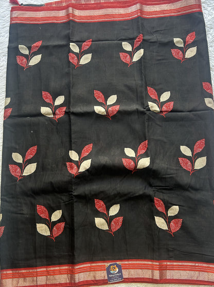 Dola Crepe Saree Black Colored Complemented with a Red Zari Border.