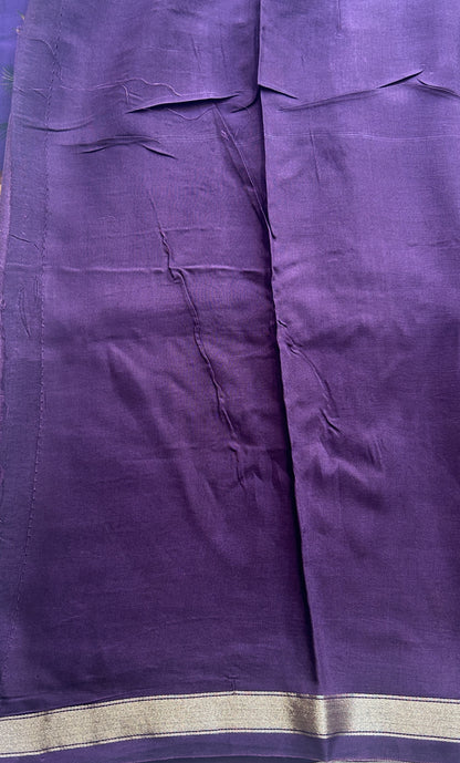 Dola Crepe Saree Violet Colored Complemented with a Zari Border.