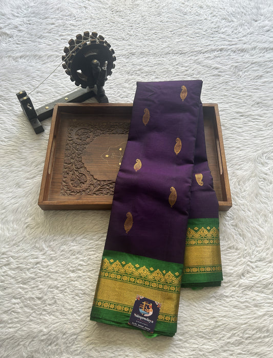 Gadwal Sico Saree Brinjal colored complemented with a Green Zari Border.