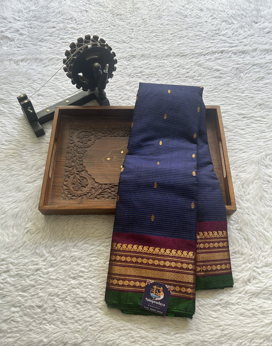 Gadwal Sico Saree Navy Blue colored complemented with a Purple Zari Border.