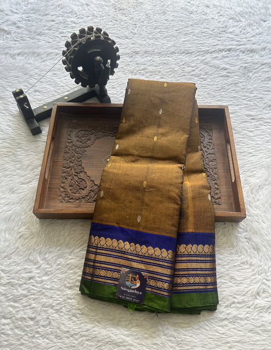 Gadwal Sico Saree Brown colored complemented with a Blue Zari Border.