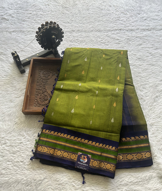 Gadwal Sico Saree Green colored complemented with a Blue Zari Border.