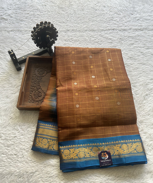 Gadwal Sico Saree Light Brown colored complemented with a Blue Zari Border.