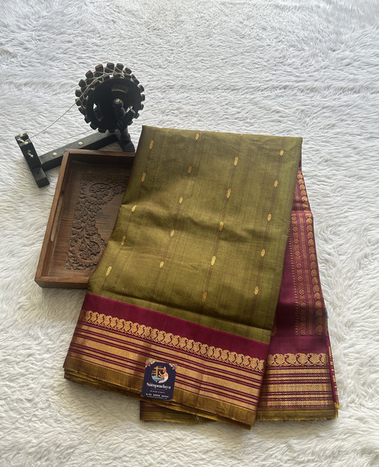 Gadwal Sico Saree Olive Green colored complemented with a Pink Zari Border.