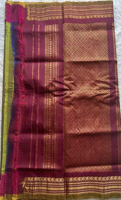 Gadwal Sico Saree Olive Green colored complemented with a Pink Zari Border.