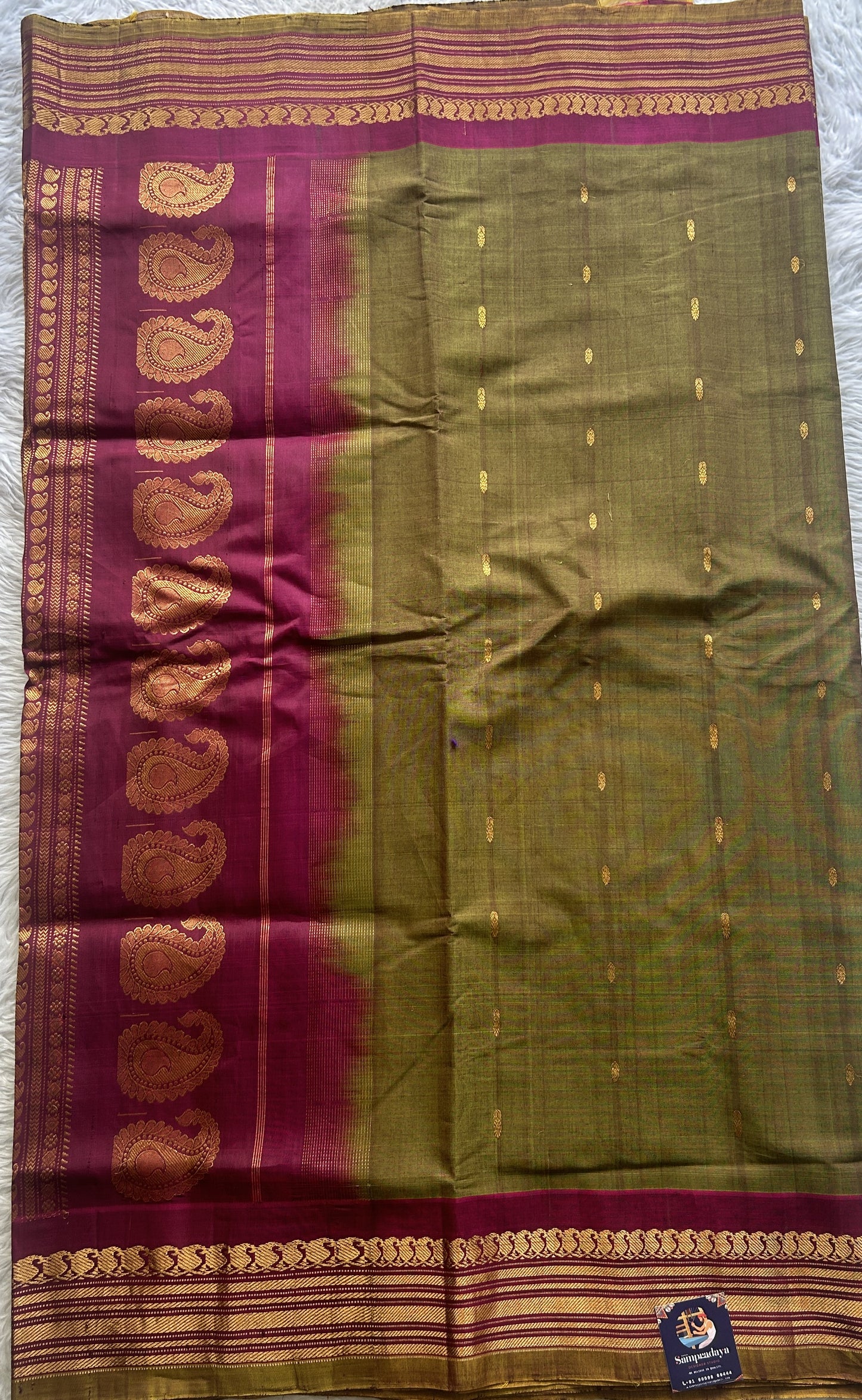 Gadwal Sico Saree Olive Green colored complemented with a Pink Zari Border.