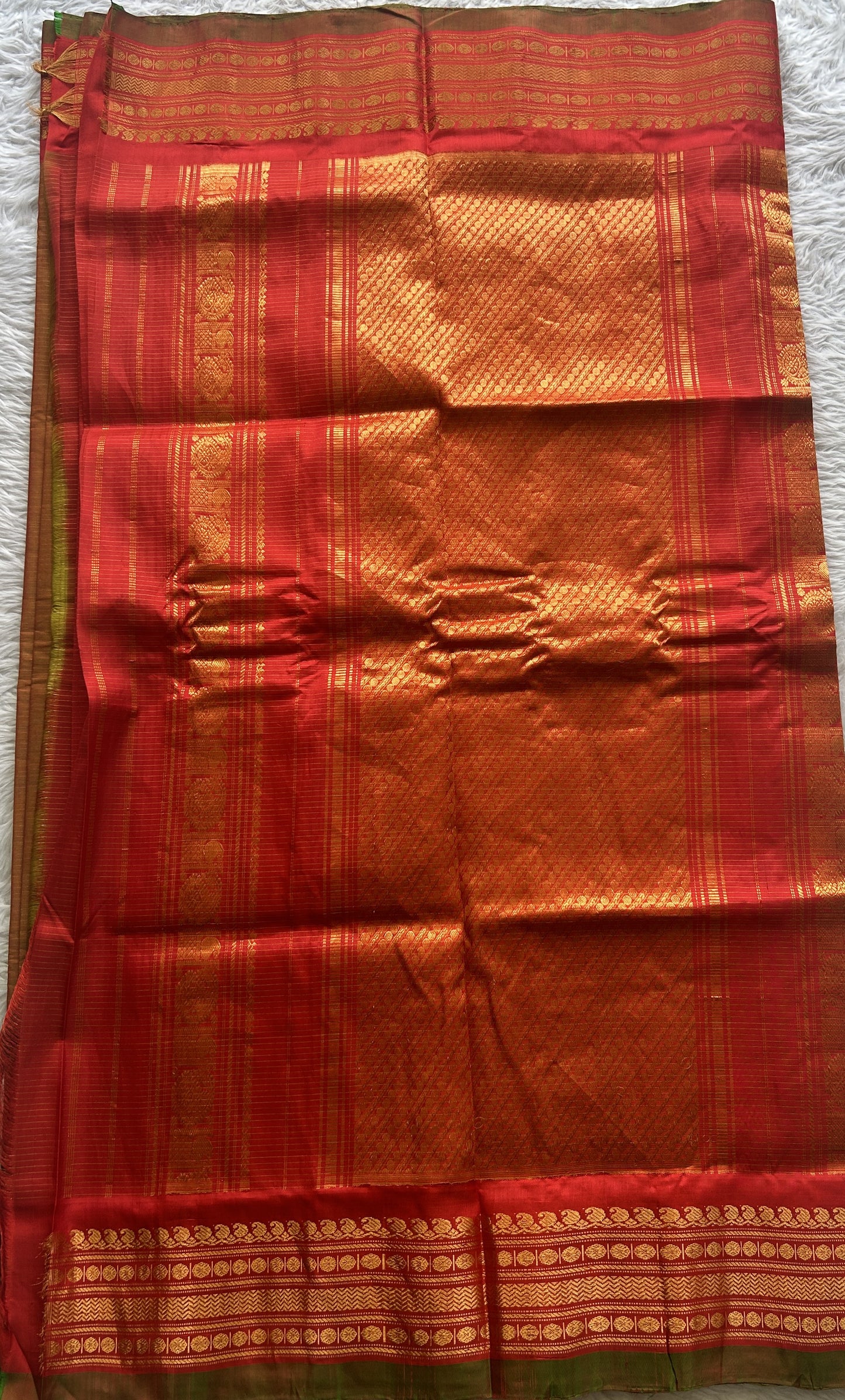 Gadwal Sico Saree Spanish Orange colored complemented with a Red Zari Border.