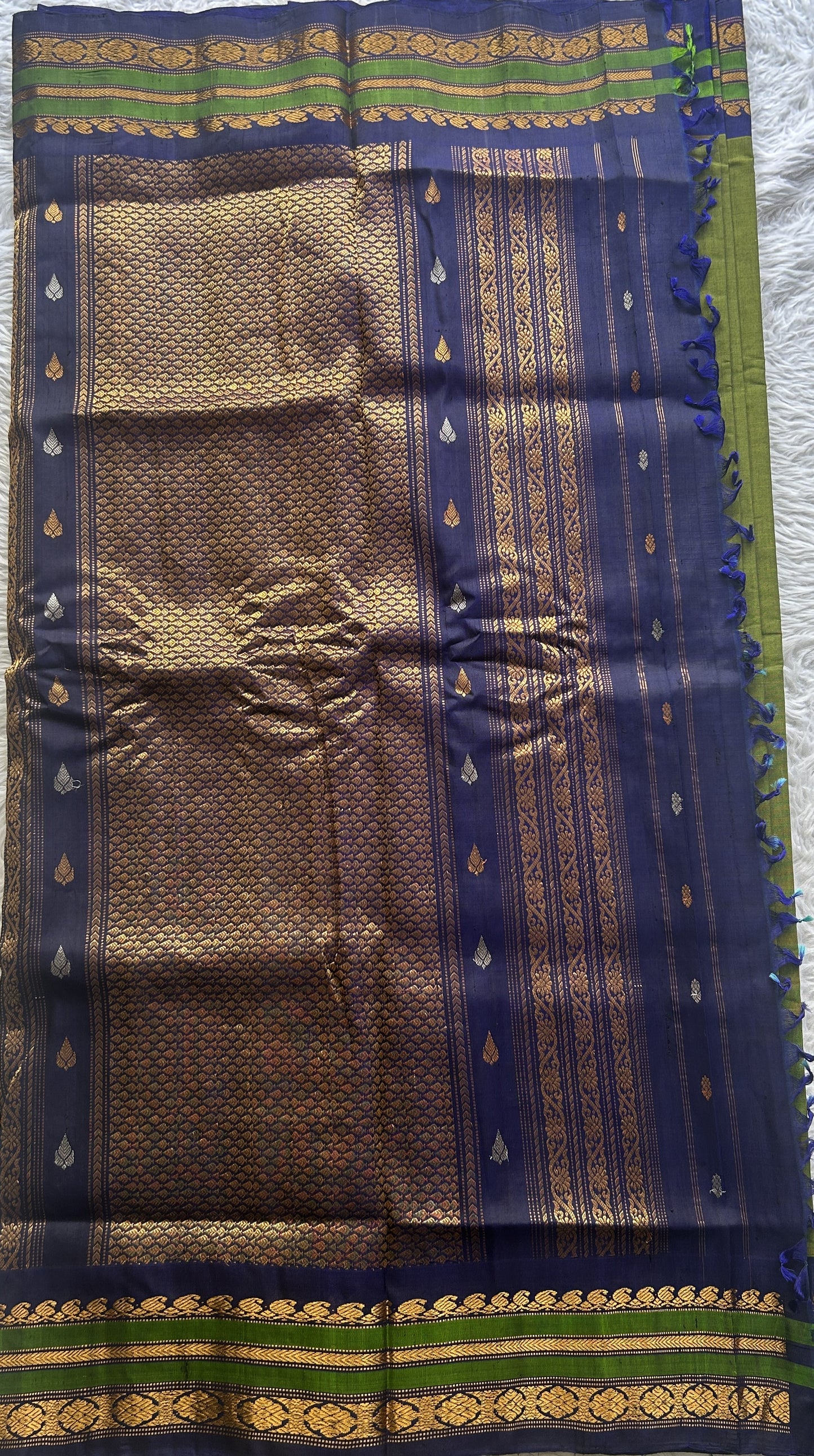 Gadwal Sico Saree Green colored complemented with a Blue Zari Border.